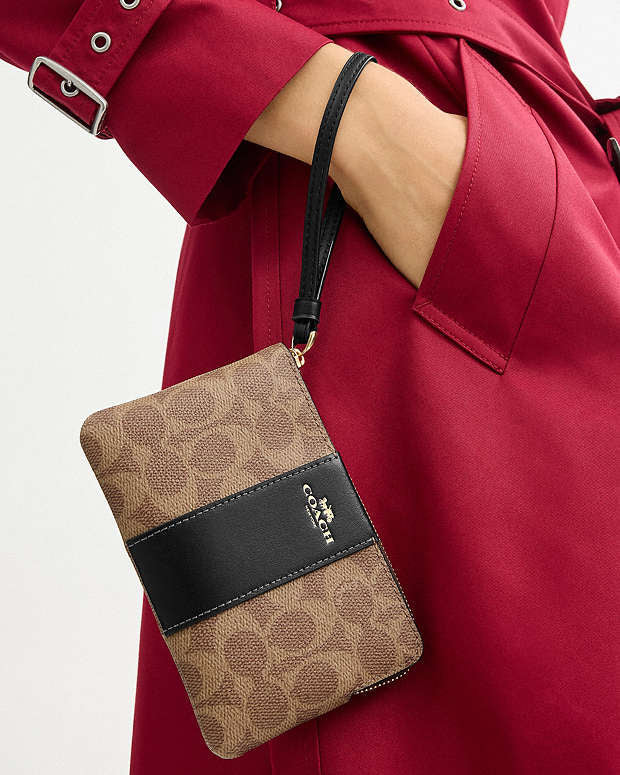 Coach Zip Wristlet In Signature Canvas With Black Stripe